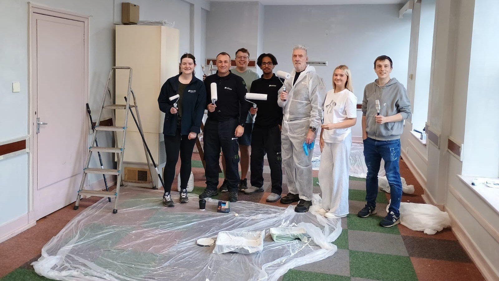 New Deer Substation extension project team getting ready to help paint New Deer Public Hall