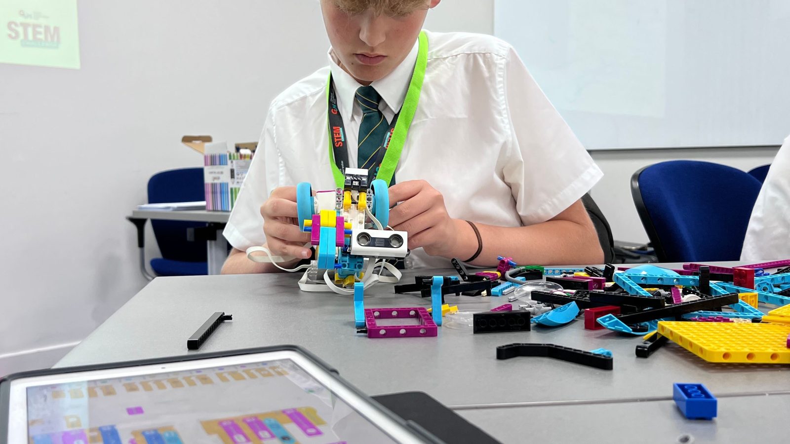 A student building a model ROV as part of the GUH STEM Challenge initiative