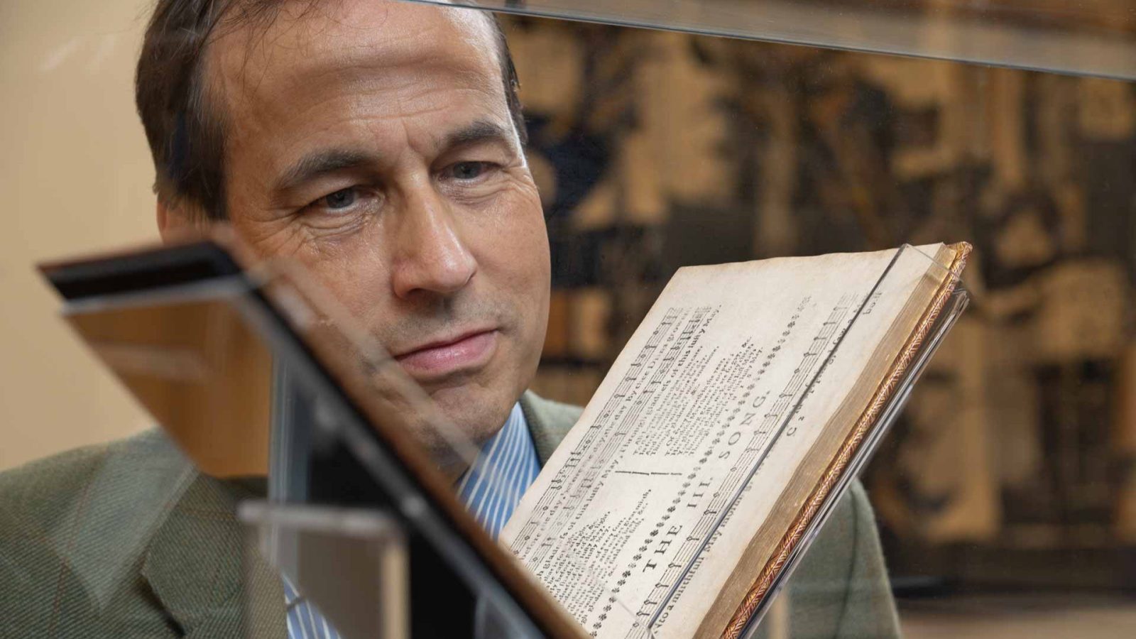 Councillor Martin Greig pictured with the music book Songs and Fancies on loan from the National Library of Scotland