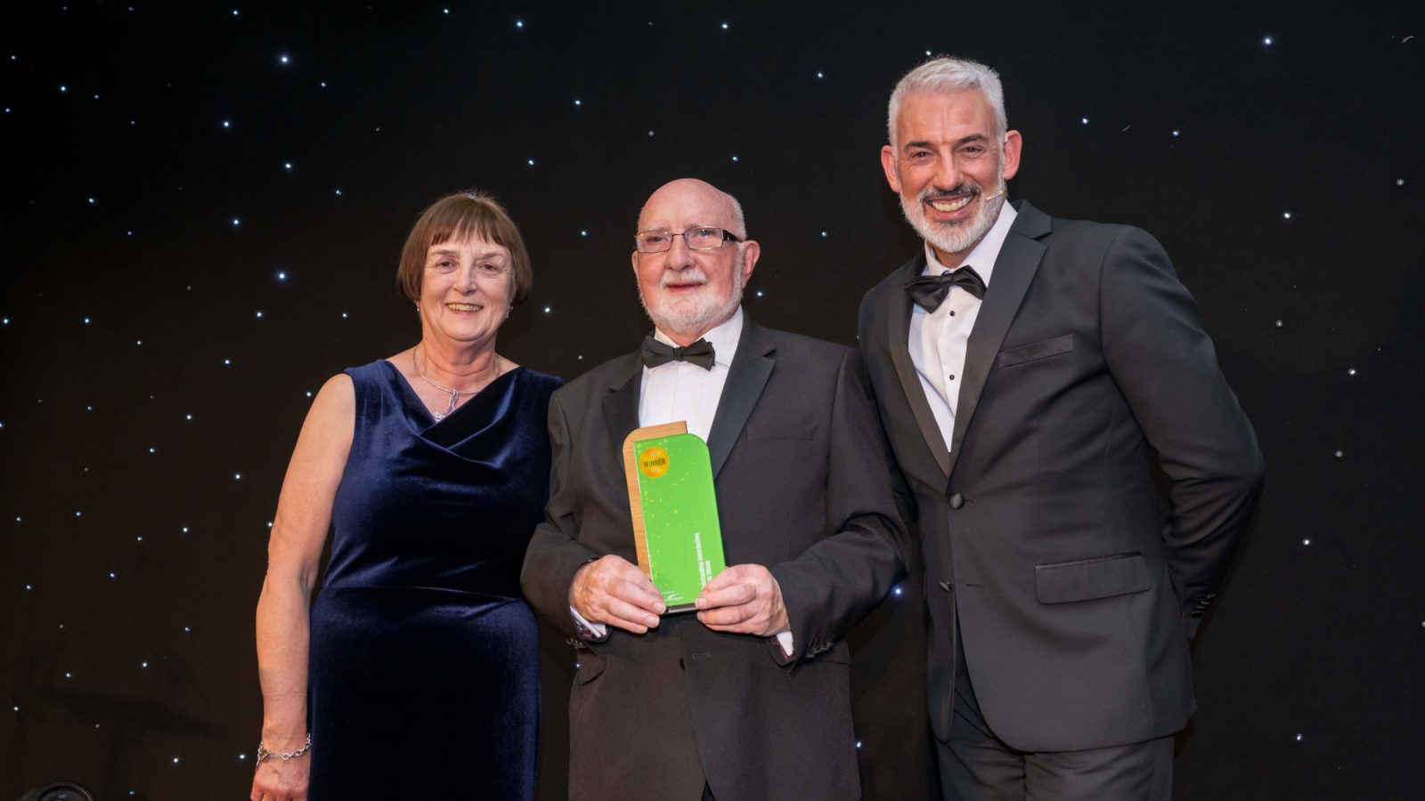 From left, Elaine Donald, Director, W M Donald, sponsor of the Outstanding Contribution award, award winner Ralph Skene, event host Chris Harvey, STV.