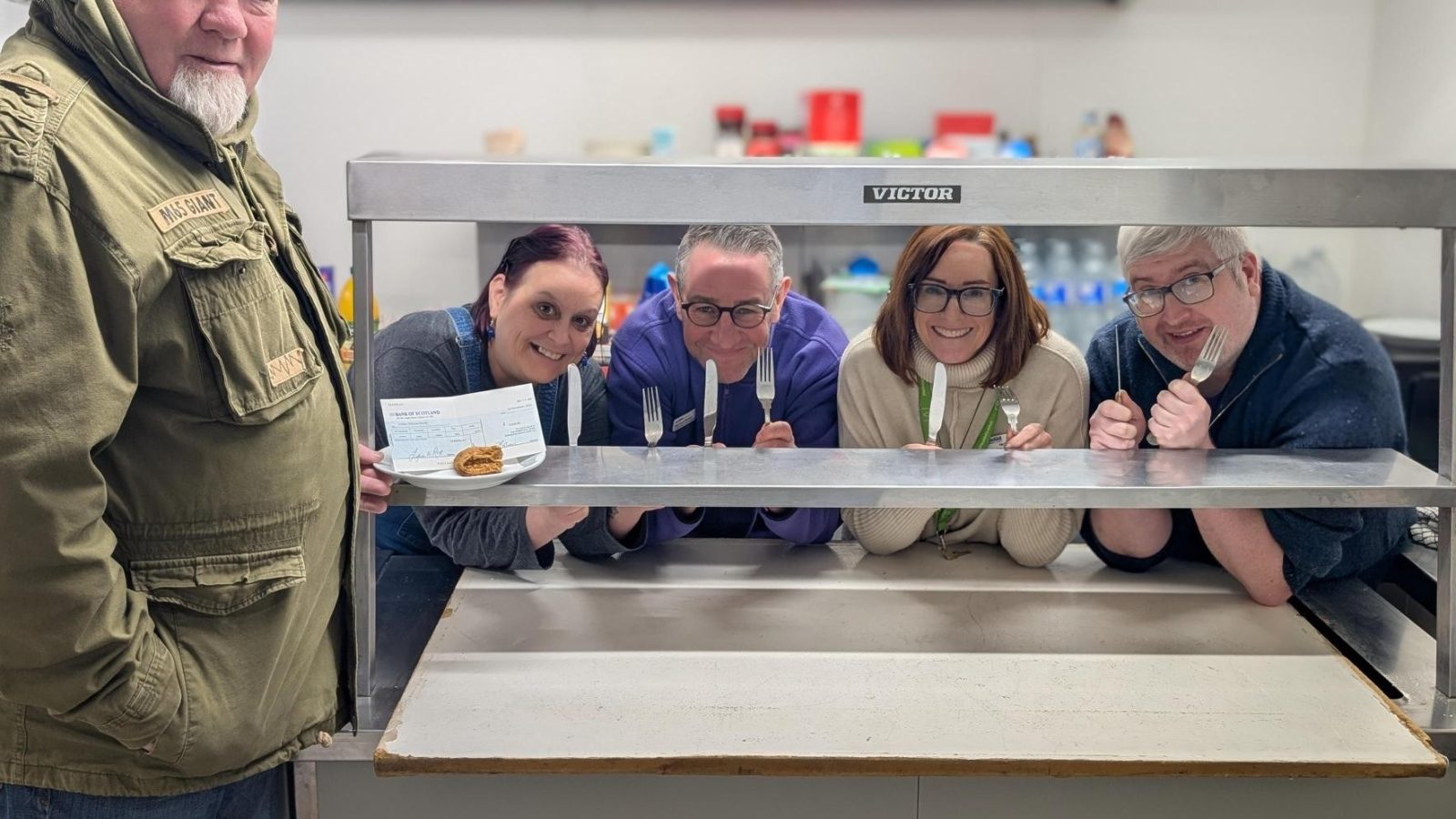 Jim Murdoch presenting the cheque to Julie Lockwood (Volunteer), Michael Parkes (Fundraising Manager North), Nicky Jones (Activities Co-ordinator), and Garry Burgess (Vice Chair of Members Committee).