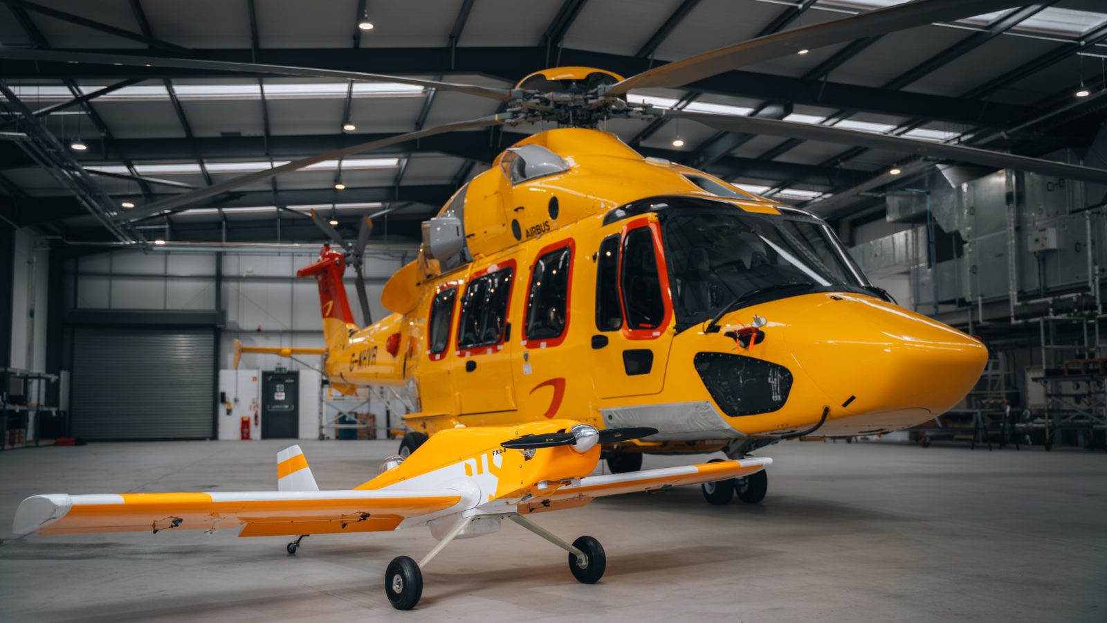 An NHV helicopter with a Flylogix drone at NHV’s hangar in Dyce, Aberdeen