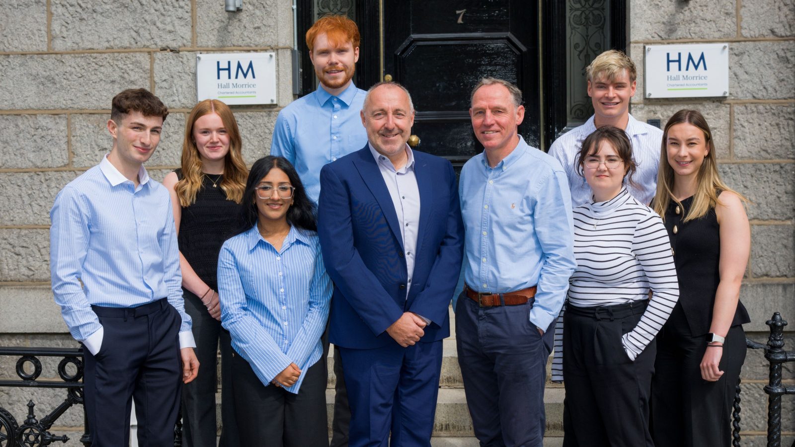 Hall Morrice Managing Partner Robert Bain (centre left) is pictured with recently appointed Partner Andrew Walker (centre right) and trainees (from left) Harry McCombie, Megan Cruickshank, Aneetta Robin, Eoghan McNally, Charlotte Slade, Lewis Sutherland, and Sophie Adams.