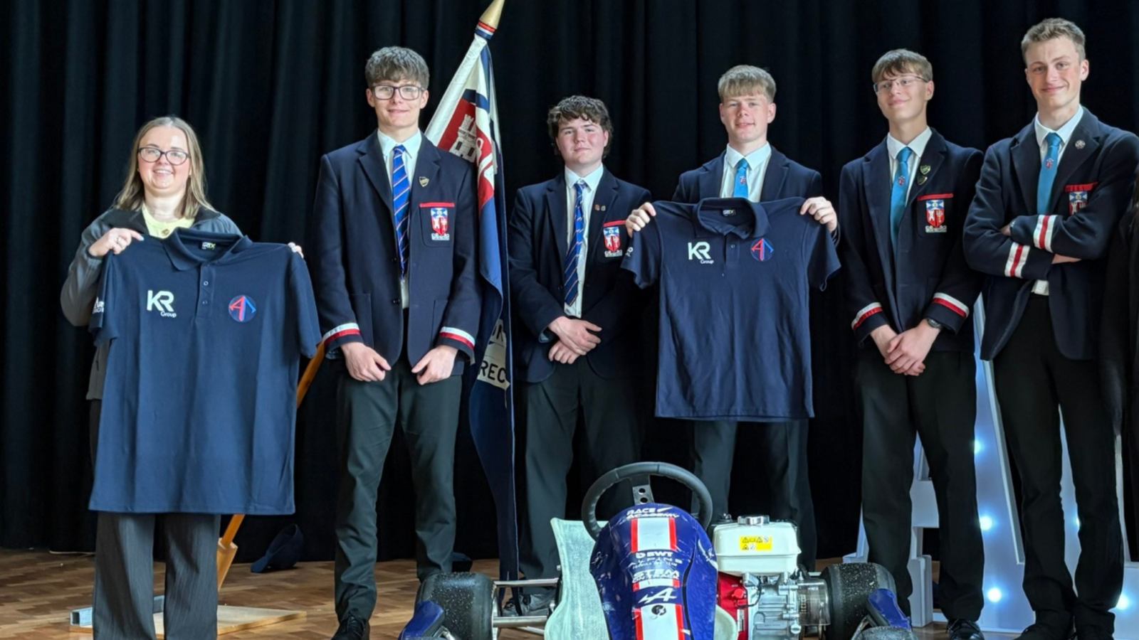 Lauren Moroney from KR Group presenting Aberdeen Racing with sponsored polo shirts.