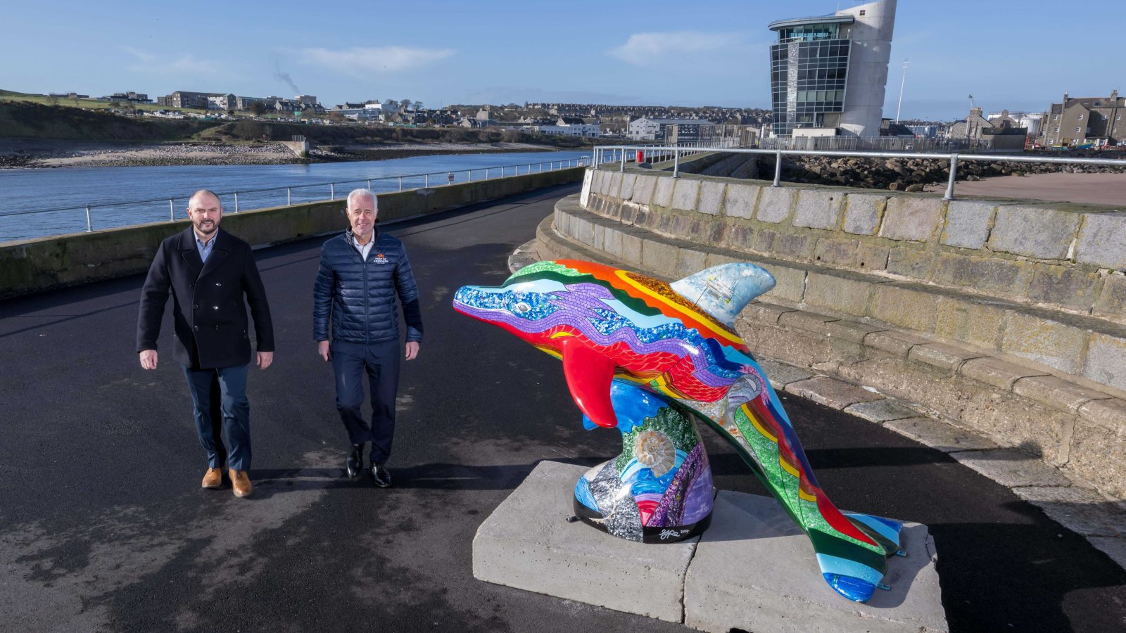 Scott Barr, Managing Director of Harbour Energy’s UK Business Unit and Bob Sanguinetti DL, CEO, Port of Aberdeen pictured with the dolphin sculpture on North Pier