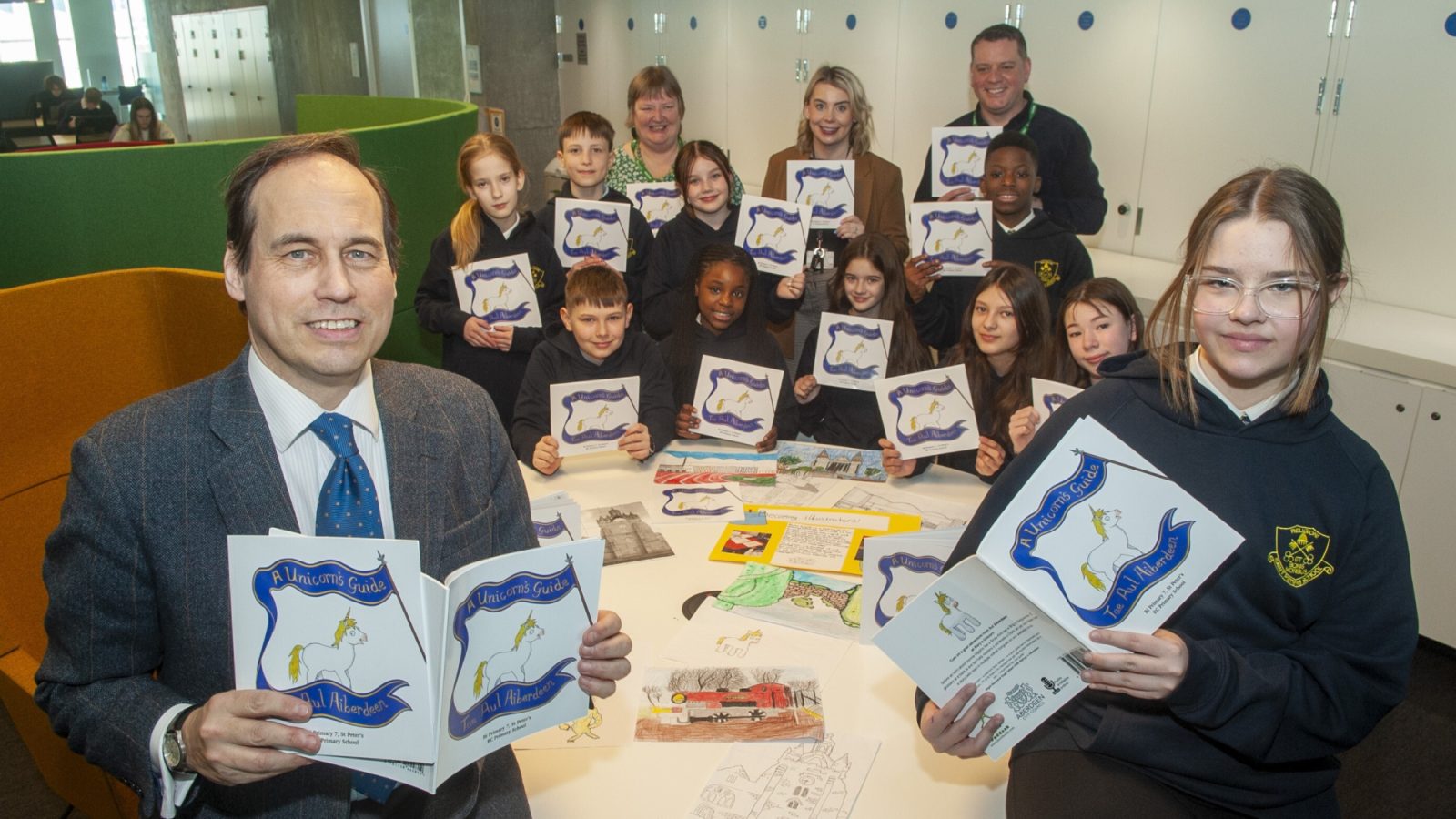 (L-R): Councillor Martin Greig with pupils from St Peter’s RC School; Jackie Ross, Co-Director, Doric Books; P7 teacher Ciara McFadden;  and Aaron Gale, Co-Director, Doric Books.