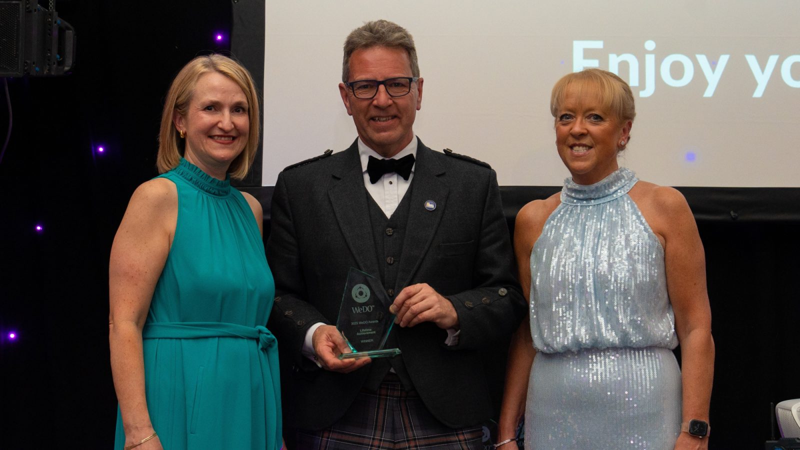 Scots businessman Gordon Wilson, managing director of Carbon Financial Partners, received a Lifetime Achievement Award at the 2025 WeDO Scotland Awards. He pictured with (left) Lesley Gordon of BTO Solicitors, and Belinda Roberts, CEO of WeDoScotland