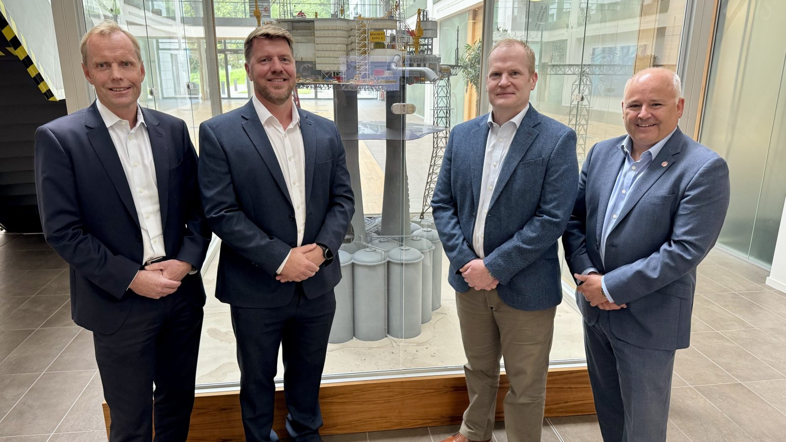 L-R: Dag Skindlo, CEO – Archer, Donald Martin, VP Decommissioning – Apache, Stuart Taylor, Director of Operations, North Sea - Apache, Phil Milton, CEO – Well-Safe Solutions in front of Apache Beryl scale model at Apache, Aberdeen.