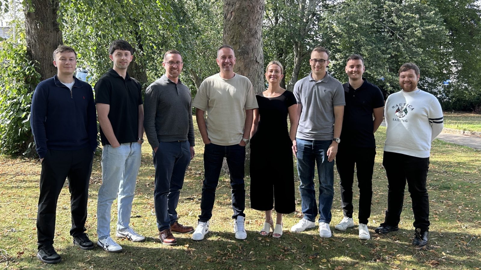 Steven Martin, software manager (3rd left), Andy Sutherland, managing director (centre), and Katie McNeil, project controls lead, with the Prism Energy software team.